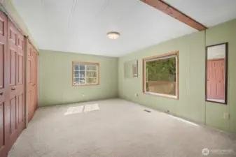 The spacious primary bedroom features two windows that fill the room with natural light.