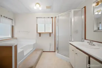 Primary Bathroom features a garden tub and walk in shower.
