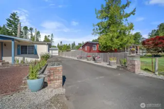 Welcoming driveway entry accented with decorative flower pots.