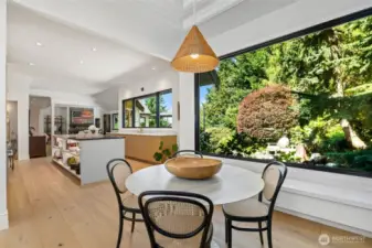Open-concept kitchen and dining area seamlessly blend modern functionality with natural beauty, ideal for entertaining.