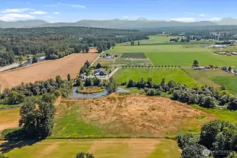 View facing East of property with lake, windmill, pastures and hay