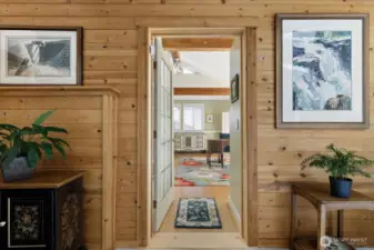 Looking into the primary bedroom suite, features large windows & a large sliding door, plenty of extra space and a full bathroom with tile flooring.