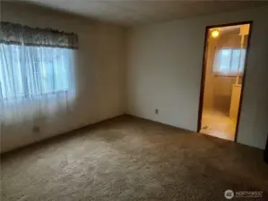 Primary bedroom looking into primary bathroom