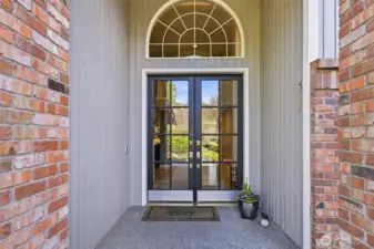 Glass french doors greet you, letting in lots of natural light.