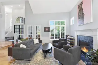 Lots of windows and a gas fireplace make this living room bright and cozy.