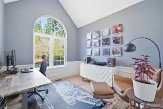 The den has a big window that looks out to the front yard.