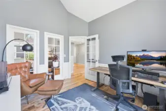 Den with windows open to the living room.