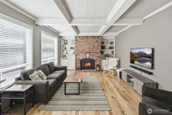 The family room has coved ceilings, a gas fireplace and windows looking out to the backyard.