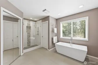 The primary bathroom has a towel warmer and private views to the back yard.