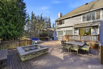 The deck in the backyard is huge and made to enjoy the private backyard. The stone fire pit is built-in.