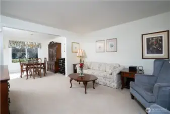 Another perspective of the formal living room showcases the open feel and natural flow of this inviting space.