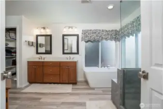 From this angle, the primary bath’s elegant fixtures and thoughtful layout are beautifully showcased.