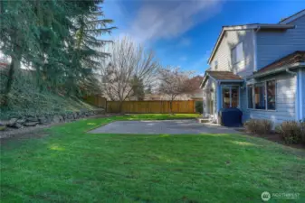 Beautiful, level backyard features a cement patio—perfect for outdoor dining, entertaining, or relaxing in the sun.