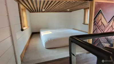 The bedroom with the sliding doors has carpeting and look at that gorgeous ceiling!