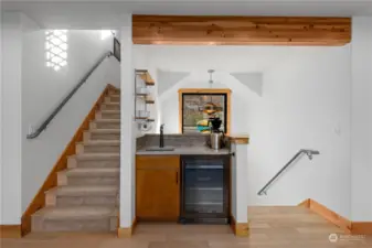 Main level coffee bar w/ stairs leading to the upper level loft area.