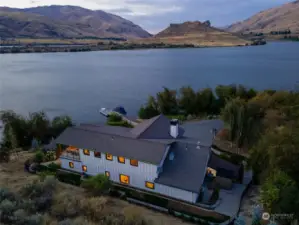 Aerial twilight view of home on 535' of waterfront on the Columbia River w/ private dock w/ boat lift and surrounding landscape on 121 acres.