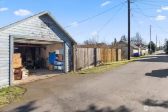 Detached garage has superb alley access.  Adjacent to the garage is a double gate and extra parking pad.  Again, excellent space for a future DADU?