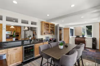 Kitchen looks out to 4-season, sunroom with warming drawers, wine refrigerator heating & cooling