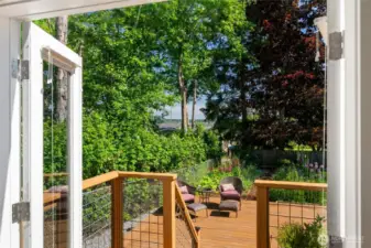 French doors lead out to a sunny deck with filtered water views!