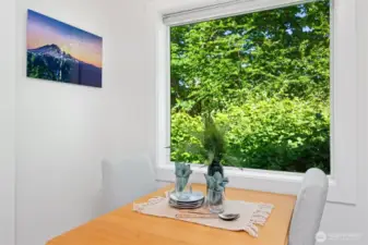 Enjoy meals in this dining nook with a lush natural view.