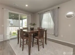 Large dining area with entry through oversized sliding glass doors out to covered patio