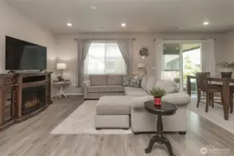 Living room is spacious and bright. Notice the gorgeous laminate flooring throughout