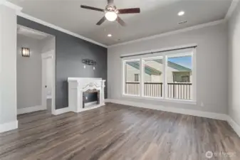 Warm and welcoming, the cozy living room is filled with natural light from expansive windows—creating the perfect retreat for relaxation and gathering