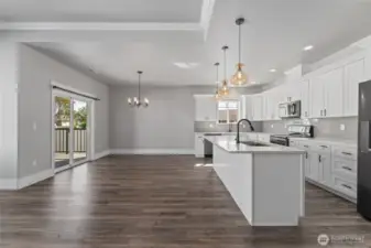 the open floor plan centers around a generous island eating bar and extends effortlessly to the covered rear deck—inviting indoor-outdoor gatherings all year long