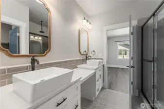 A stunning primary en-suite boasting double sinks, upscale finishes, a generous walk-in closet, and a fully tiled shower that elevates everyday living