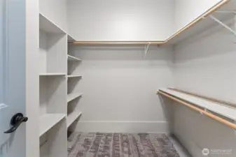 Spacious and smartly organized, this walk-in closet offers ample storage with built-in organizers for effortless style and order