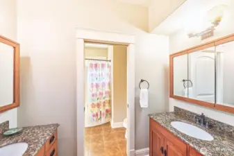 Pocket doors for privacy lead to 2 sinks.