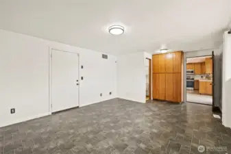 Bonus room. Entrance into garage on the left. Half bath. Built in cabinets. Entrance into kitchen.