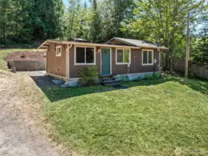 Septic pump and tanks are at the front of the home. Septic drain field is at the top of the property and follows the property line. Well is behind the home and has a 15 gpm flow.