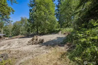 Property line extends all the way to the large tree in the background. Over 1 acre on the 2nd parcel with 2 strong and flat areas for building a home or multiple cabins.