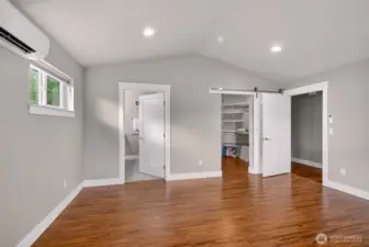 Primary looking from the front of the room back to the hall, ensuite bath & walk-in closet
