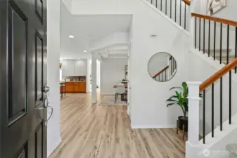 Welcome! To a huge entry, coat closet, views to the open floorplan and  soaring vaulted ceilings