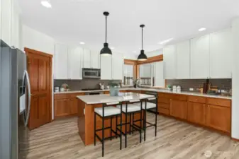 This kitchen was lovingly  updated with on-trend creamy cabinets, tile, and countertops. It's a must see!