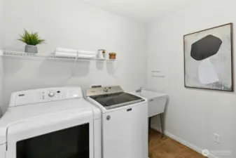 This large laundry room is upstairs and features a sink for hand washing if needed.