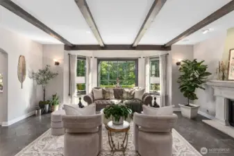 While large picture windows beckon you into your formal living room.