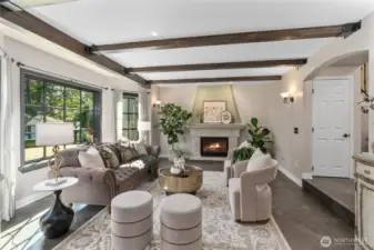 Featuring a warm gas fireplace, luxurious tile floors and rustic wood beams.