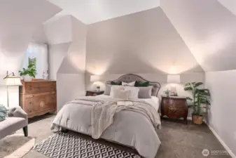 Primary bedroom has vaulted ceilings and alcove windows Primary bedroom (with king sized bed).
