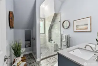 Luxurious walk in shower with heated towel rack.