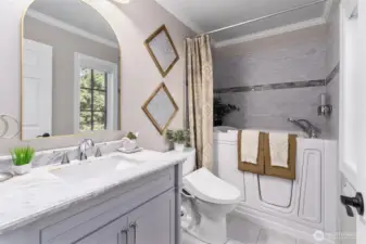 Guest bathroom with jetted walk-in spa tub.