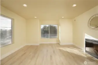 Living room with abundant light and cozy fireplace