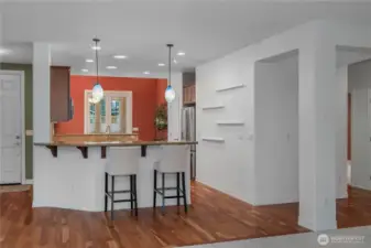 Beautifully updated kitchen featuring quartz countertops, hardwood floors, a new gas oven and range, dishwasher, and microwave. Upgraded cabinetry with pull-out shelves and a charming eat-in space make this kitchen both stylish and functional.