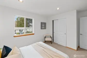 Laundry room with side-by-side washer and dryer and overhead cabinetry for additional storage. Compact layout provides convenient space for laundry tasks.