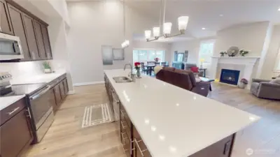 The slab quartz kitchen island/bar is glorious- perfect for prepping meals, bellying up to the bar and visiting, or informal dining.