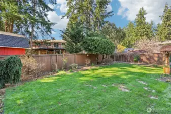 Fully fenced level backyard with beautiful garden