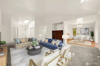 Virtually staged open living room with vaulted