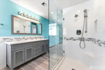 Tiled shower and dual vanities